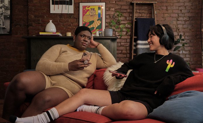 A non-binary trans woman and a non-binary person enjoying time on the couch.jpg